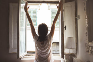 Woman stretches in the morning.